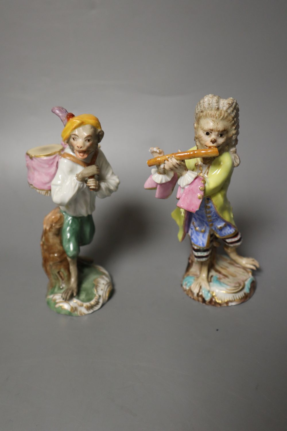 Six 19th century Meissen monkey band figures and another Volkstedt example, tallest 15cm
